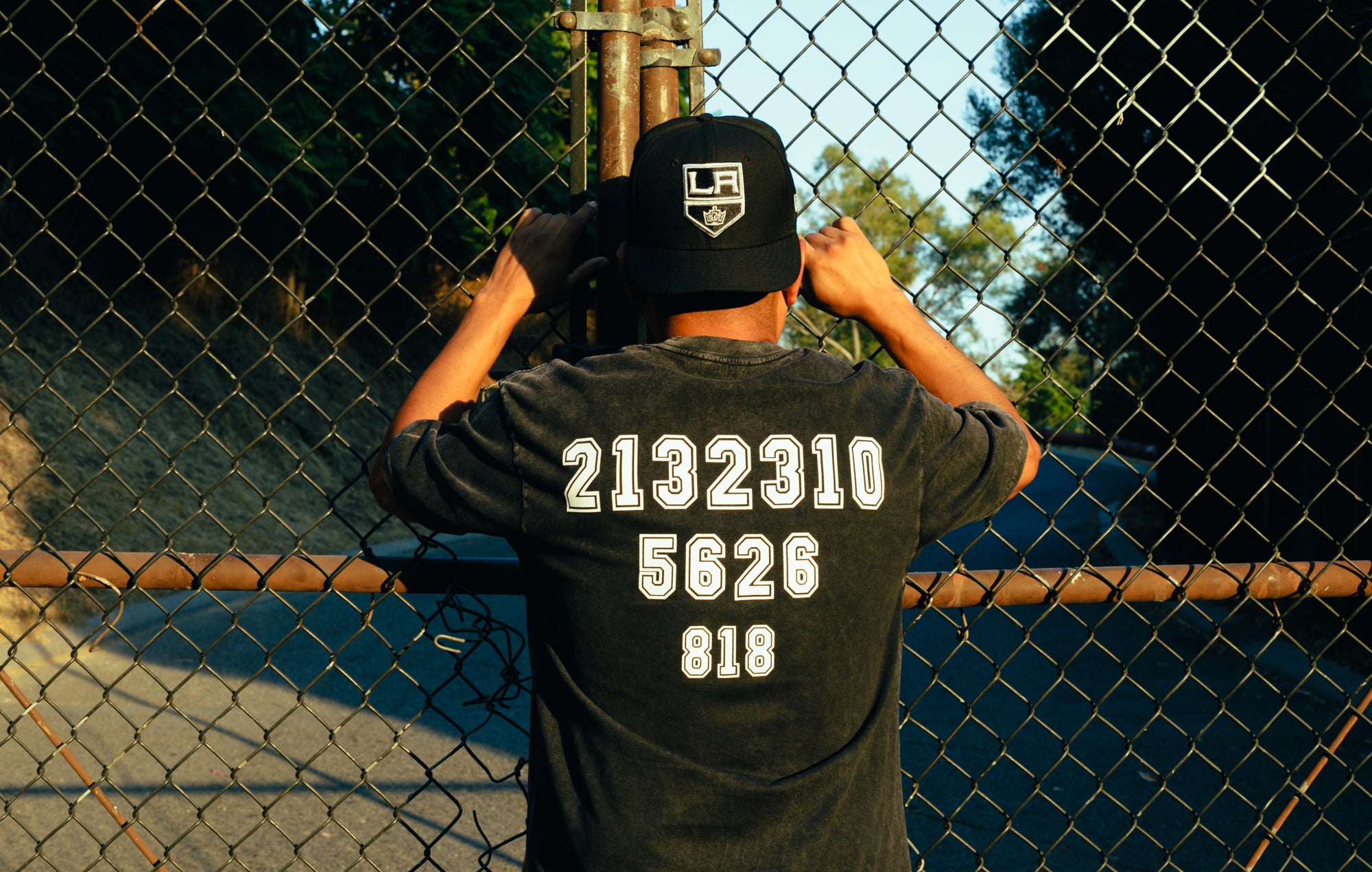 a picture of the back of the washed "Area Codes" shirt that displays 2132310 5626 818